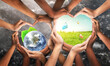 © Puttachat - Environmental unity and global earth day and international environment concept with world community as hands protecting nature from pollution and climate change. Symbol and shape created from hands.