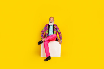 Canvas Print - Full size photo of handsome pensioner mister sit white cube dressed colorful pink classy garment isolated on yellow color background