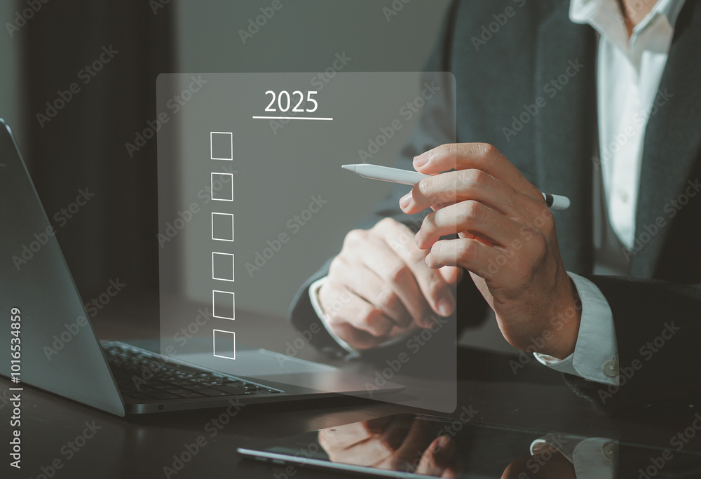 Businessman planning with checkbox and text 2025 on desk text in