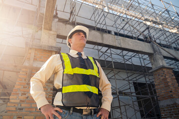 Contractor engineer architect working in construction building industry architect engineering profession, professional standing confident with arms crossed. Male caucasian wearing safety vest hardhat