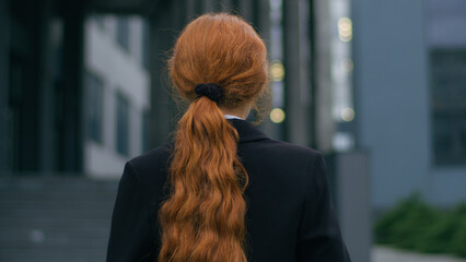 Beautiful confident successful Caucasian business woman portrait female girl businesswoman CEO student worker turning back looking camera holding laptop pc computer device posing outdoors city office