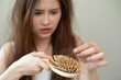 © Pormezz - Serious, worried asian young woman, girl holding, show damaged loss hair, problem after brushing, hair fall out on hand. Health care of beauty treatment. Portrait isolated on background, copy space.