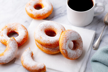 Canvas Print - Coffee with classic donut on white marble table background. Top view. Close up.