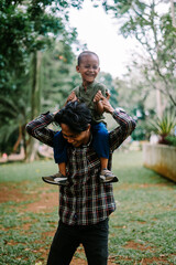 Father and son playing together, capturing a moment of joy and bonding.