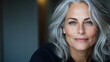 © svastix - A captivating portrait of an elegant mature woman with vibrant gray hair, exuding confidence and poise. Her serene expression adds depth to the imagery's beauty.