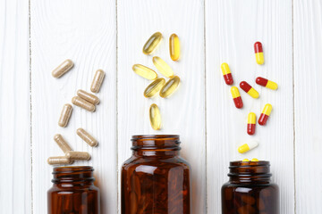 Wall Mural - Pharmacist. Many different pills and overturned bottles on white wooden table, flat lay