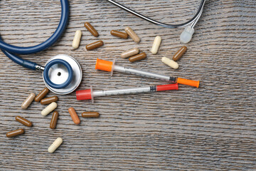 Wall Mural - Pharmacist. Many different pills, stethoscope and syringes on wooden table, flat lay