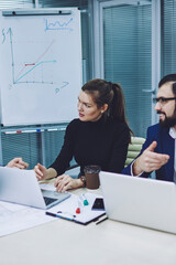 Confident male and female traders spending time for cooperation together in modern company office, caucasian business people in formal wear discussing ideas for productive conference in workspace