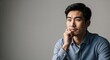 © Arceli - Thoughtful Asian male young adult in neutral studio pictorial