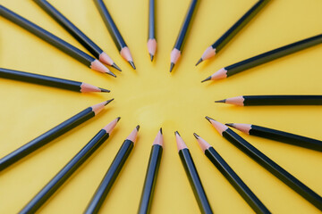 Man is drawing and yellow with pencils. pencil white education concept. a and white pencils lying on a yellow . a man is lying on a white with lifestyle yellow pencils.