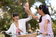 © auremar - female friends enjoying cycling on a summer day