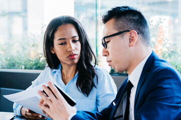 Professional young man and woman meeting in cafe