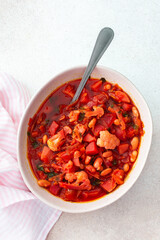 Red soup with beet, beans and vegetables and cauliflower, chickpea cutlets and mixed salad with avocado, delicious hearty breakfasts or lunches, top view of a set table with food