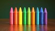 © Meawlee - Bright crayons arranged in rainbow order on a table, creative play.
