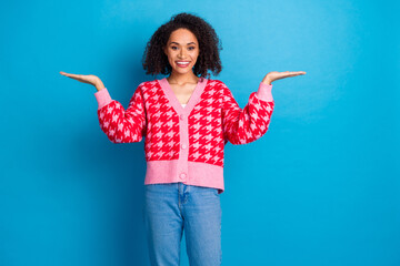 Sticker - Portrait photo of american beautiful girl with curly hair wearing red stylish cardigan balance scales sign isolated on blue color background