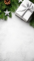 A white gift box adorned with silver decorations and arranged with a pine tree branch creates an elegant minimalist design perfect for holiday greetings