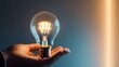 © xiden - an image of an illuminated light bulb in a human hand, symbolizing an idea or inspiration. Focus on the glow of the bulb and the details of the hand