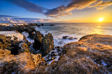 Fototapeta Góry - Gatklettur arch on Iceland during sunrise