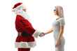 © Ljupco Smokovski - Young blond woman shaking hand with santa claus