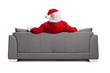 © Ljupco Smokovski - Rear view shot of Santa claus sitting on a sofa