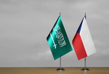 Table flags of Czech Republic and Saudi Arabia on grey blurred background