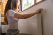 © Valeriia - Adjusting the radiator at home during the heating season