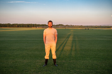 Farmer in plantation farm field. Man farmer in meadow field. Farmer business man in field. Farmer works in farm field. Agricultural business concept. Growing food, Harvest. Farm in America.