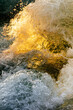 © Andrew Kornylak - Warm light coming through turbulent rapids in the surface of water