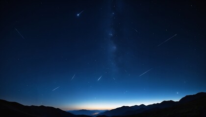 stars twinkling over mountain peaks at dusk