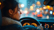© FATNA - Woman driving through a city at night with blurred lights in the background.
