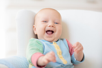 Wall Mural - little baby on white chair