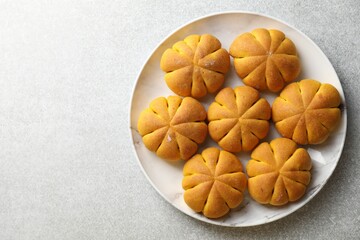 Sticker - Tasty pumpkin shaped buns on grey table, top view. Space for text