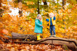 © famveldman - Kids playing in autumn park
