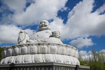 Peterborough, Ontario, Canada / 05-18-2024: The stone statue of Happy Buddha in Peterborough, Ontario, Canada