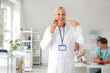 © Pixel-Shot - Female doctor with apple in clinic