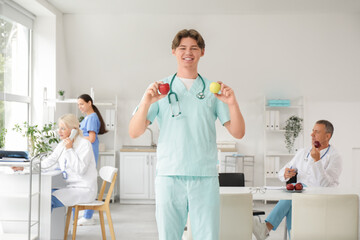 Sticker - Young male doctor with apples in clinic