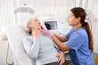 © JackF - Young female cosmetologist in gloves examining face skin of elderly female client before beauty procedure in spa center indoors