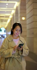 Poster - Vertical view of asian woman use mobile phone at outdoor