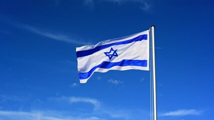 Wall Mural - Slow motion, flag of Israel fluttering in the wind against a blue sky