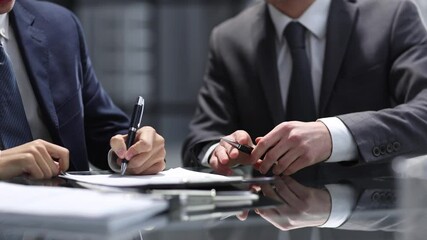 Wall Mural - Businessmen shake hands with each other in close-up in the office