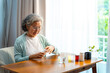 © CandyRetriever  - Asian senior mature woman patient taking medicine pill with drinking water from a glass for relief disease in bedroom Elderly retired woman taking vitamins complex supplement for self-care at home.