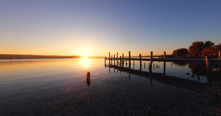 Wall Mural - sunset over sea shore,calm ripple water and old fishing pier video