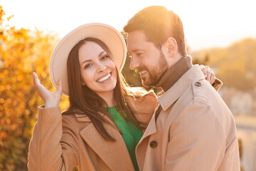 Wall Mural - Beautiful couple spending time together in autumn park