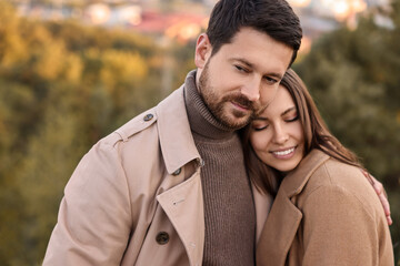 Wall Mural - Beautiful couple hugging in park on autumn day