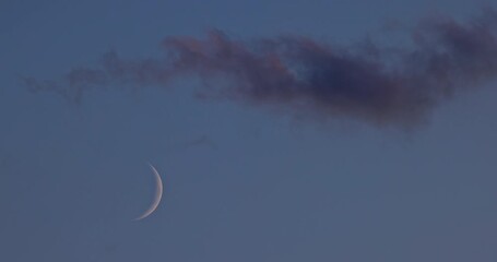 Wall Mural - starry sky with half moon in scenic sunset cloudscape video