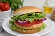© New Africa - Delicious vegetarian burger with chickpea cutlet on light table, closeup