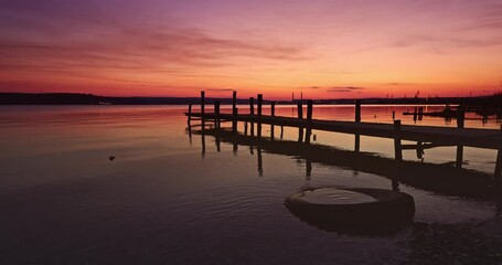 Wall Mural - sun dawn with colorful cloudscape over old wooden fishing pier and sea shore video, sunset over the 