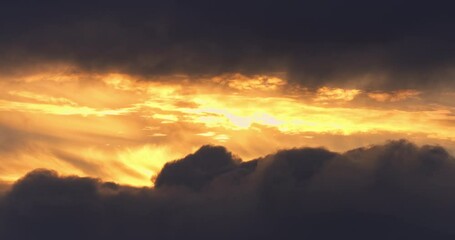 Wall Mural - rising sun behind dramatic cloudscape, scenic sunset or sunrise with clouds video