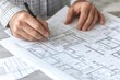 © ImagePulse - Engineers holding building specifications and adjusting details on floor plans, close-up of hands and documents