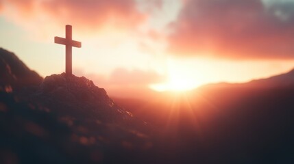 Wall Mural - A cross stands on a mountain peak, beautifully backlit by a vibrant sunset that casts warm colors across the horizon